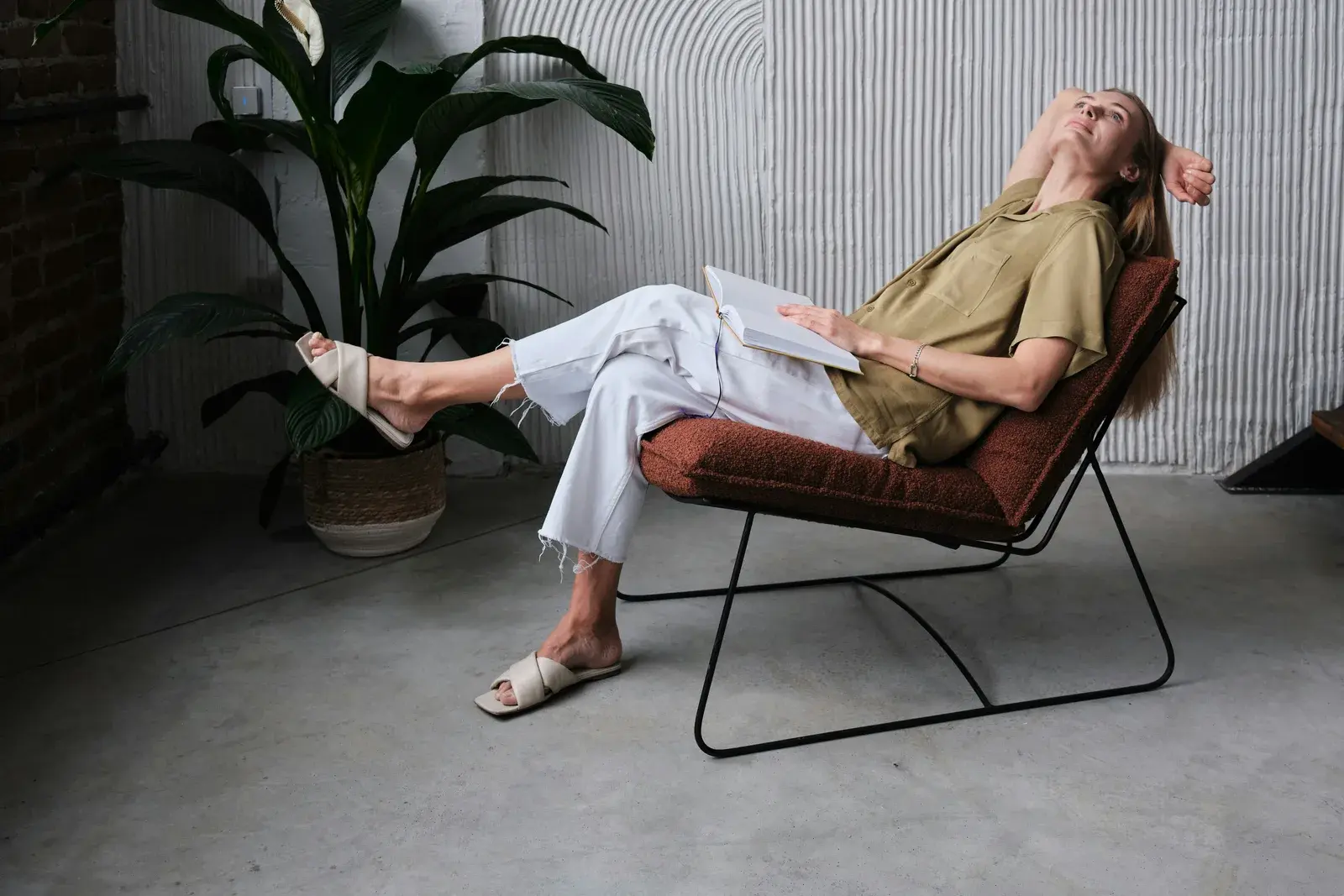 Woman relaxing in a modern chair